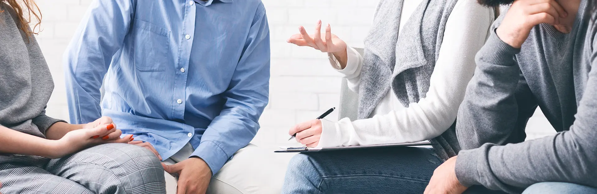 Imatge de fons d'un grup de persones en una sessió de psicologia.